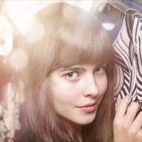 portrait of a beautiful teenage girlan her warderobe, with bokeh
