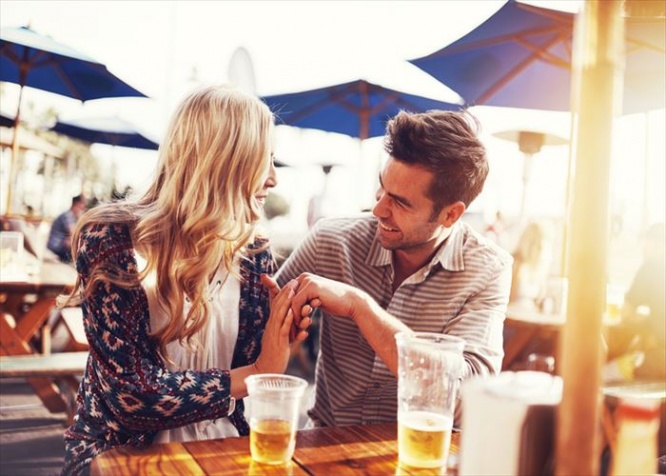 romantic couple drinking beer with artistic lens flare