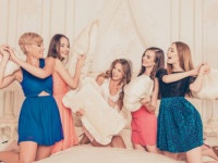 Pretty girls celebrating a bride’s bachelorette party and fighting with pillows