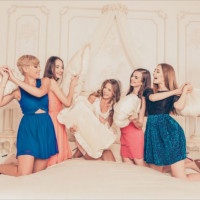 Pretty girls celebrating a bride’s bachelorette party and fighting with pillows
