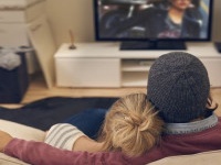 Rear view shot of a young couple watching TV together