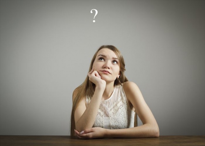 Young woman and question mark above head.