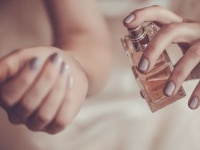 bride applying perfume on her wrist