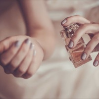 bride applying perfume on her wrist
