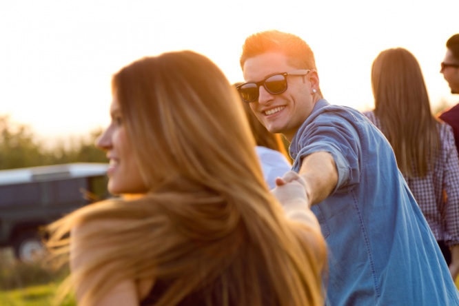 Portrait of group of friends having fun in field.