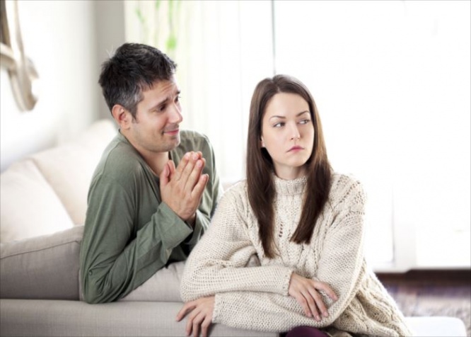 Image of young man begging his girlfriend to forgive him