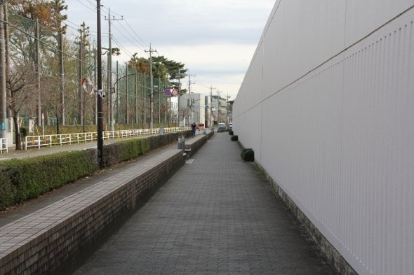 府中刑務所の塀が無機質に長く続いている