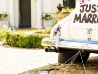 Just married sign and cans attached to convertible car. Horizontal shot.