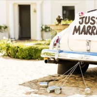 Just married sign and cans attached to convertible car. Horizontal shot.