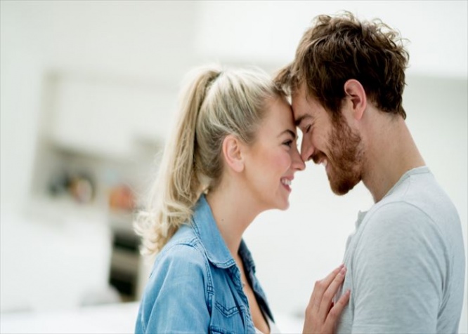 Beautiful portrait of an affectionate couple looking happy at home - relationship concepts