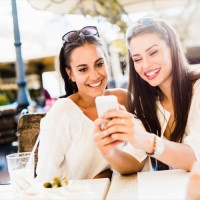 Two young girls talking and smiling during lunch break