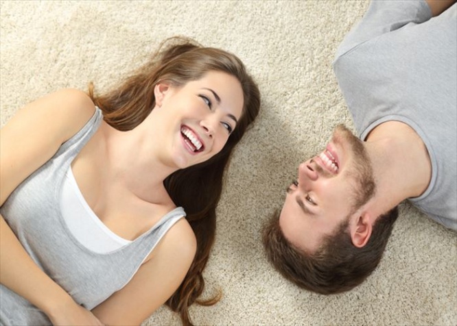 Happy couple lying and laughing