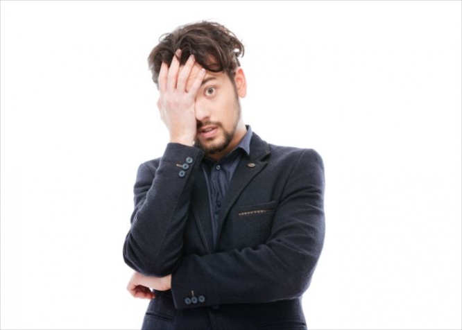 Sad businessman standing isolated on a white background