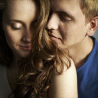 Young man enjoying smell of hair of his sweetheart