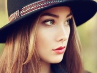 Portrait of young beautiful woman in autumn coat. Girl in hat. Fashion photo