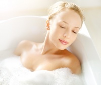 Attractive girl relaxing in bath