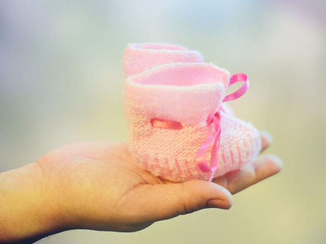 Woman hand holding bootees