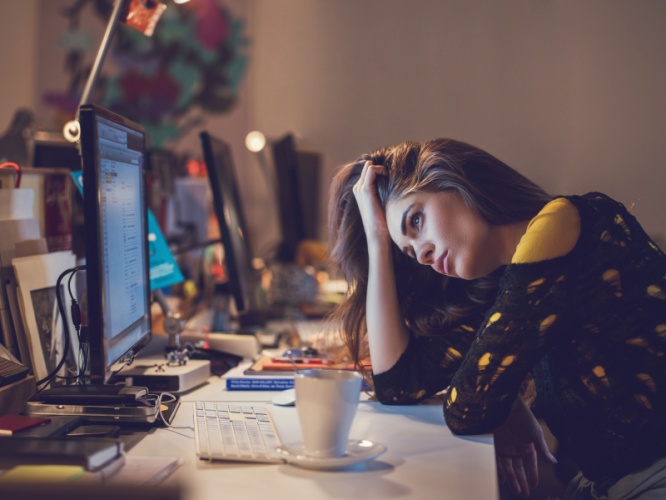 Exhausted woman working late in the office.