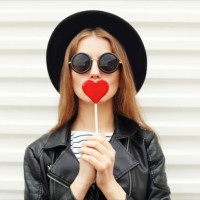Fashion sweet woman having fun with lollipop over white background