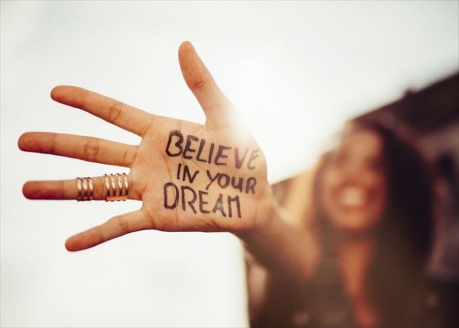 Closeup of a teenage girl's hand with the phrase 