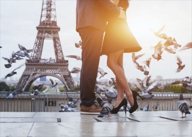 couple near Eiffel tower in Paris, romantic kiss