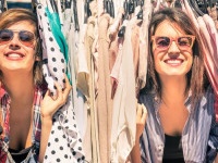 Young beautiful women at the weekly cloth market - Best friends sharing free time having fun and shopping in the old town in a sunny day - Girlfriends enjoying everyday life moments