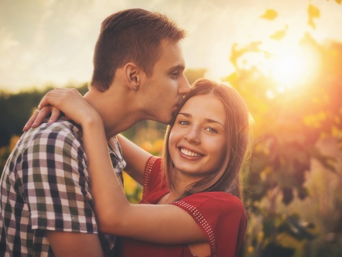 Attractive couple enjoying romantic date in the Countryside, sunset in the background