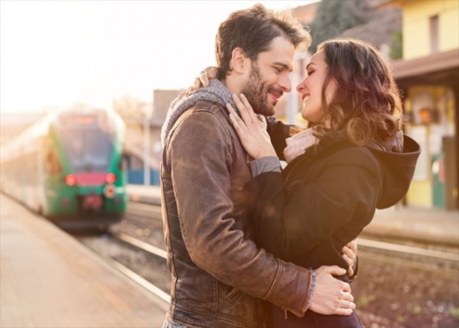 Happy couple embracing on railway station platform