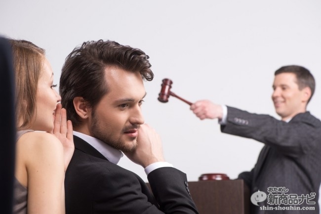 young beautiful brunette whispering into ear. handsome man listening to woman at auction