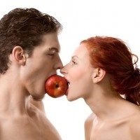 Couple biting an apple, isolated on white