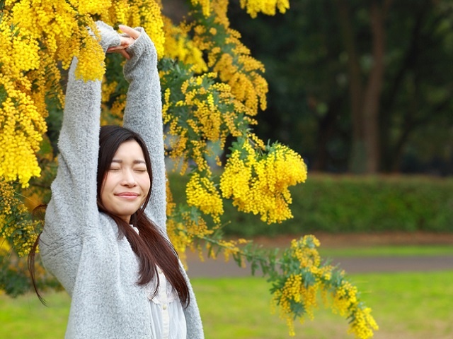 young woman stretching in park