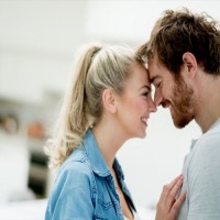 Beautiful portrait of an affectionate couple looking happy at home - relationship concepts