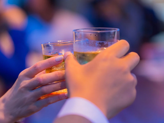 Couples toasting at bar counter
