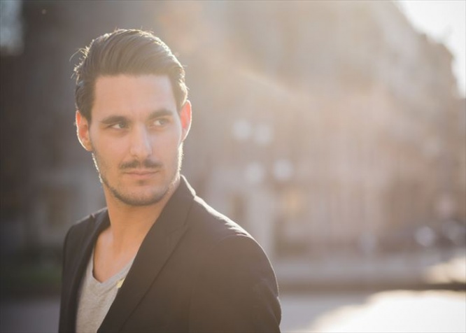 Portrait of a young italian boy posing through the street of the city