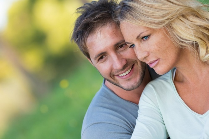 Close up of beautiful couple sitting in the nature, selective focus