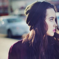Stock image portrait of urban teen walking outdoors with a blank stare