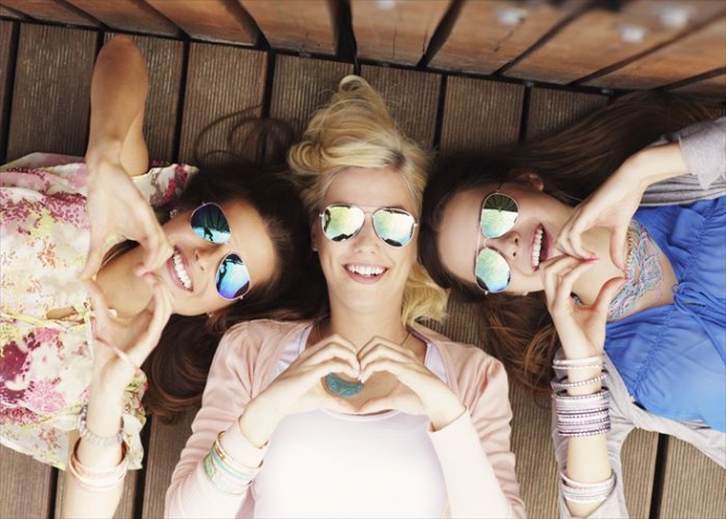 A picture of group of happy friends showing hearts