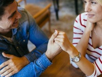 Beautiful couple in love flirting in restaurant and bonding