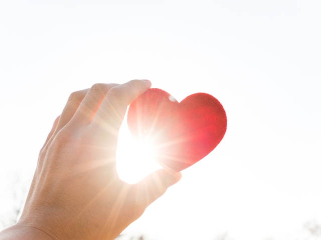 Holding heart under the sun