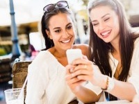 Two young girls talking and smiling during lunch break