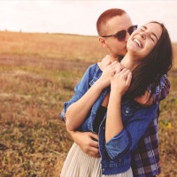 Landscape portrait of young beautiful stylish couple sensual and having fun outdoor. Film effect