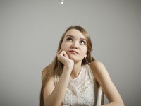 Young woman and question mark above head.