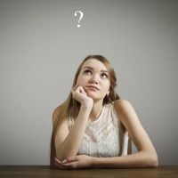 Young woman and question mark above head.