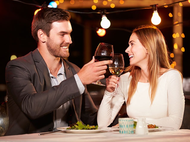 Couple eating dinner at rooftop restuarant