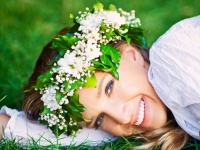Beautiful smiling woman with a flower wreath on her head