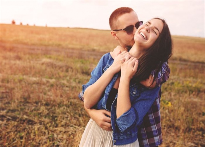 Landscape portrait of young beautiful stylish couple sensual and having fun outdoor. Film effect