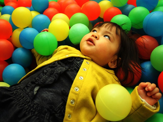 Japanese baby girl playing in ball pool (1 year old)