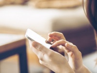 Young happy woman  typing on smart phone