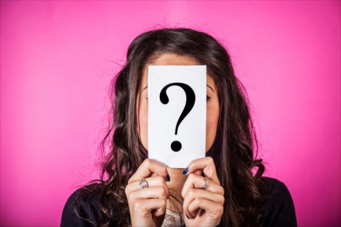 Doubtful Woman holding Question Mark