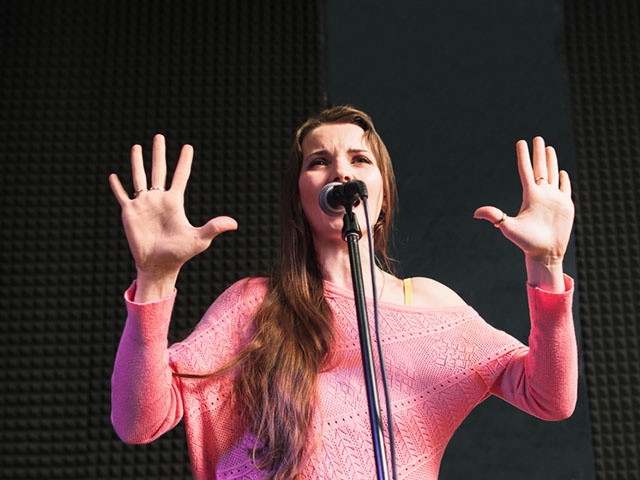 Women performing against the microphone